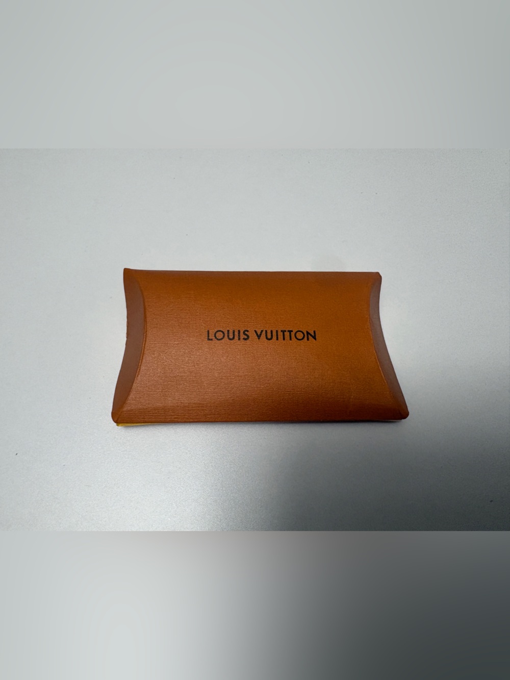 Louis Vuitton shoelace sleeve and white original shoe laces. (New)